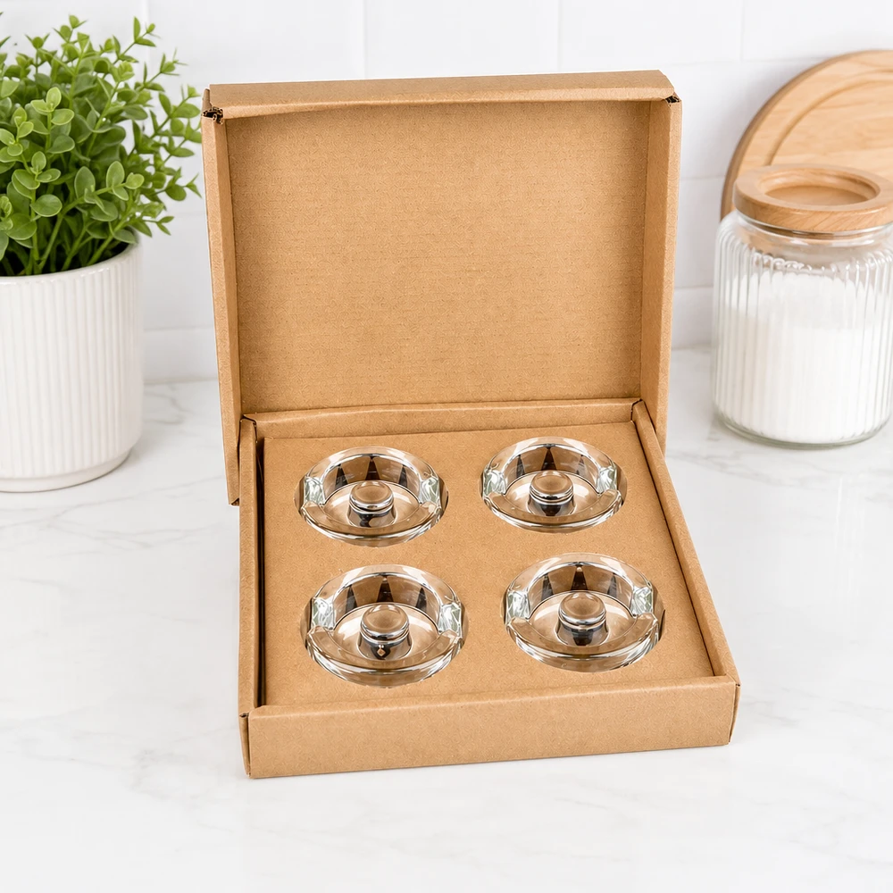 Fermentier-Glasgewichte mit Griff 4er Set UNiTWIST UNiTWIST Fermentier-Glasgewichte 4er Set geöffnet in brauner Schachtel neben Pflanze und Vorratsglas