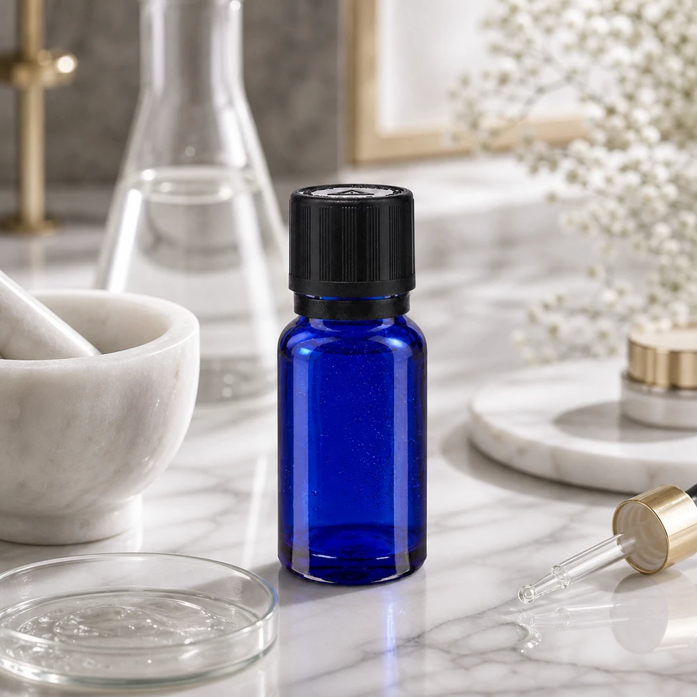 Apothekenflasche blau 10ml Tropfer Giessring 1mm schwarz Kindersicherung Blindenwarnsymbol Originalitätsverschluss Kleine kobaltblaue Apo-Tropfflasche 10ml schwarzer Sicherheitsverschluss neben Glaskolben und Mörser